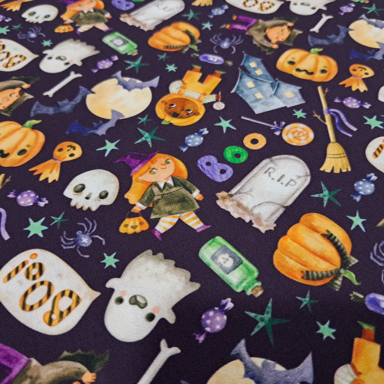Cotton Halloween Boo Spooky fabric - Halloween-themed cotton poplin fabric with drawings of ghosts, pumpkins, spiders, bats, candy, and more on a violet background. The fabric is 150 cm wide and is made of 100% cotton.