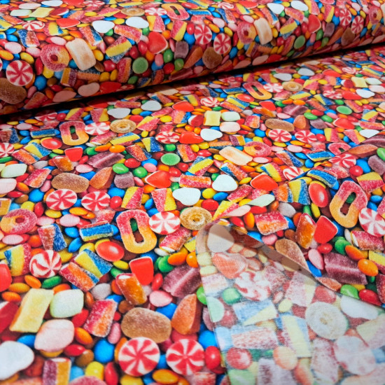 Cotton Candy 3D Effect fabric Multicolor cotton poplin fabric with a photographic print of sweets and candies.