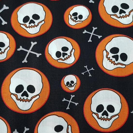 Cotton Skulls Circles fabric - Cotton fabric with skulls in orange circles on a black background.