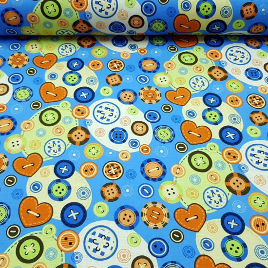 Cotton Colorful Buttons fabric - Cotton fabric with button drawings of different models and colors on a colorful background where blue color predominates. The fabric is 135cm wide and its composition is 100% cotton.