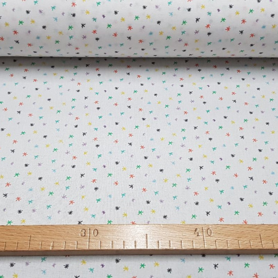 Cotton Stars Asterisks Colors fabric - Poplin organic cotton fabric with star patterns in different colors asterisk on a white background. Fabric made in Spain. The fabric is 150cm wide and its composition is 100% cotton.