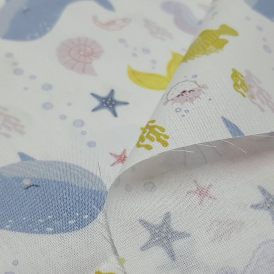 Cotton Mermaid Shells fabric - Organic cotton poplin fabric with a child theme featuring drawings of mermaids, sea shells, puffer fish, corals, starfish, bubbles and more related to the marine world... all on a white background. The fabric is 150c