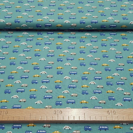 Cotton Vehicles Turquoise Green fabric - Children's cotton fabric with small drawings of cars and buses in blue, mustard, beige and white colors on a turquoise green background. The fabric is 150cm wide and its composition is 100% cotton.