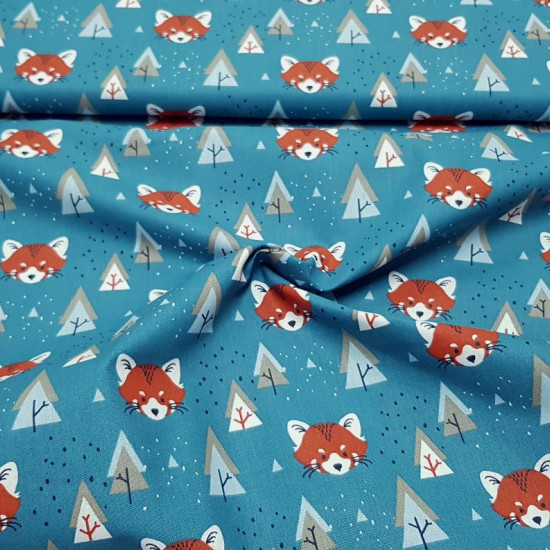 Cotton Foxes and Trees fabric - Children's cotton fabric with drawings of fox faces and trees in Nordic style on an petrol blue background. The fabric is 150cm wide and its composition is 100% cotton.