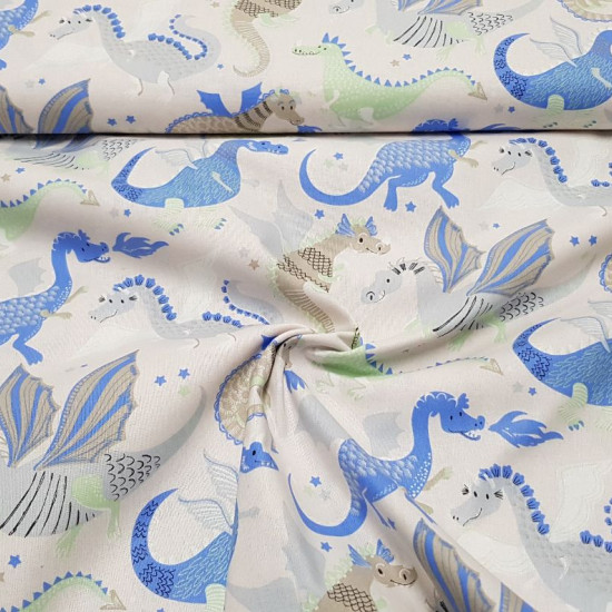 Cotton Funny Dragons fabric - Cotton fabric with drawings of funny dragons in shades of blue, green and gray on a light background with stars. The fabric is 155cm wide and its composition is 100% cotton.