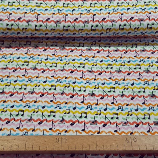 Tela Algodón Notas Musicales Colores - Tela de algodón con dibujos de notas musicales sobre un fondo multicolor. La tela mide 150cm de ancho y su composición 100% algodón