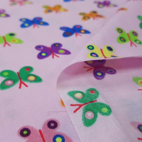 Cotton Butterflies Pink fabric - Cotton fabric with drawings of colored butterflies on a pink background. An explosion of colors! The fabric is 150cm wide and its composition is 100% cotton.