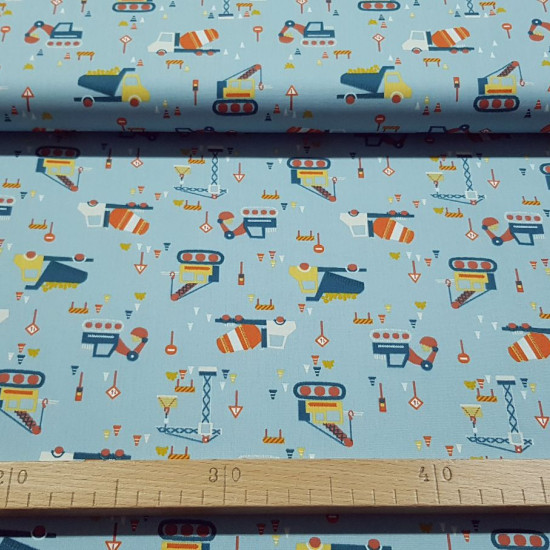 Cotton Construction Vehicles Blue fabric - Children's cotton fabric with drawings of construction vehicles, signs and construction cones on a blue background. The fabric is 150cm wide and its composition is 100% cotton.