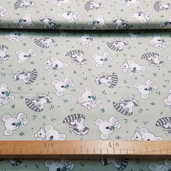 Cotton Koalas Raccoons fabric - Children's cotton poplin fabric with drawings of koalas and raccoons on a light background. The fabric is 150cm wide and its composition is 100% cotton.