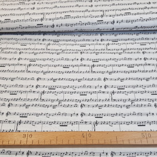 Cotton Musical Scores fabric - Cotton poplin fabric with drawings of musical scores on a white background. The fabric is 150cm wide and its composition is 100% cotton.