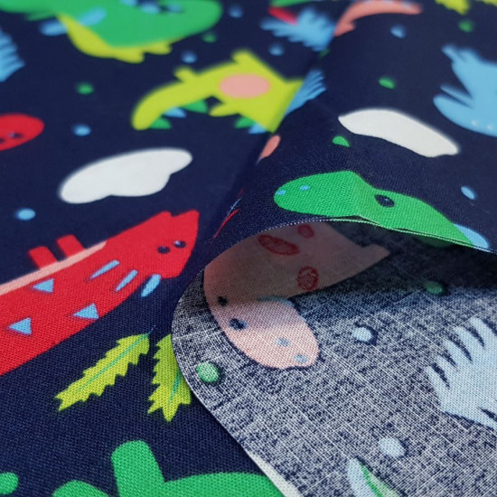 Cotton Dinosaurs Colors fabric - Cotton poplin fabric with drawings of dinosaurs in bright colors on a dark blue background. The fabric is 145cm wide and its composition is 100% cotton.