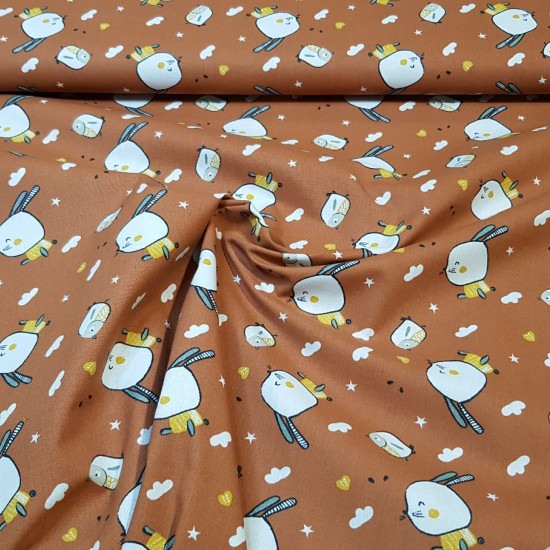 Cotton Bunnies Little Birds fabric - Cotton poplin fabric with bunny and bird drawings on a brick-colored background with white clouds, stars and other small drawings. The fabric measures 150cm and its composition is 100% cotton.