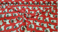 Tela Algodón Cachorritos - Tela de algodón popelín con dibujos de cachorritos sobre un fondo de color rojo. La tela mide 140cm de ancho y su composición 100% algodón.