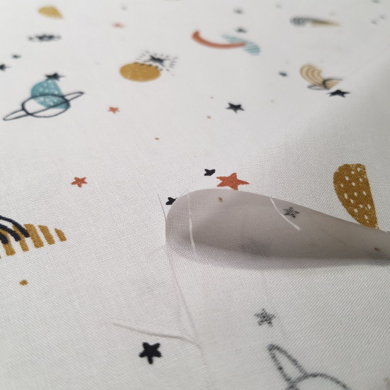 Cotton Planets and Stars fabric - Organic cotton poplin fabric with drawings of planets, stars, moons and eyes in various colors on a white background. The fabric measures 145cm wide and its composition is 100% cotton.