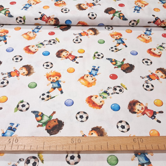 Cotton Playing Soccer fabric - Cotton poplin fabric with a children's theme featuring children playing soccer on a white background. The fabric is 150 cm wide and is made of 100% cotton.