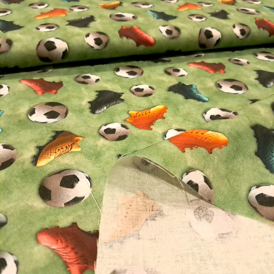 Cotton Soccer Balls 3D Effect fabric Cotton Soccer Balls 3D Effect fabric - 3D-effect cotton poplin fabric with soccer balls and multicolored sneakers on a mottled green background reminiscent of grass. The fabric is 150 cm wide and is made of 100% cotton.