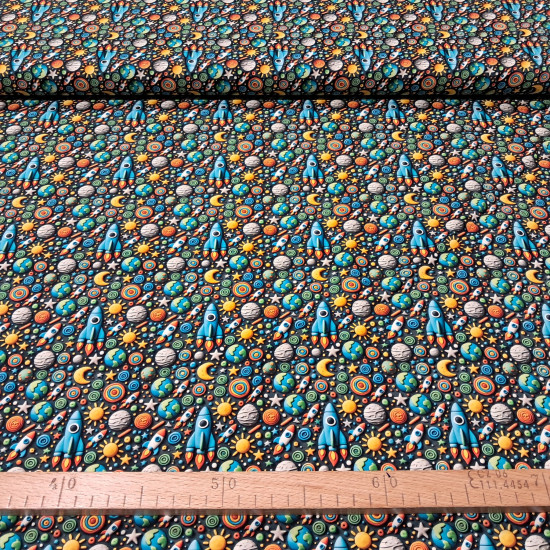 Cotton Rockets Space 3D Effect fabric Cotton Rockets Space 3D Effect fabric - Cotton poplin fabric with 3D clay-effect drawings of rockets, spaceships, planets, suns, and stars on a dark background. The fabric is 150cm wide and 100% cotton.
