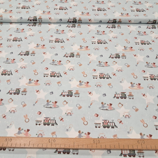 Cotton Trains Babies fabric - Cotton poplin fabric with drawings of toy trains, pacifiers, teethers, baby crib mobiles, babies... on a light colored background with white stars. The fabric measures 150cm wide and its composition is 100% cotton.