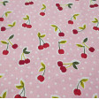 Cotton Cherry Pink fabric - Cotton fabric with cherry drawings on a pink background with white polka dots. The fabric is 150cm wide and its composition is 100% cotton.