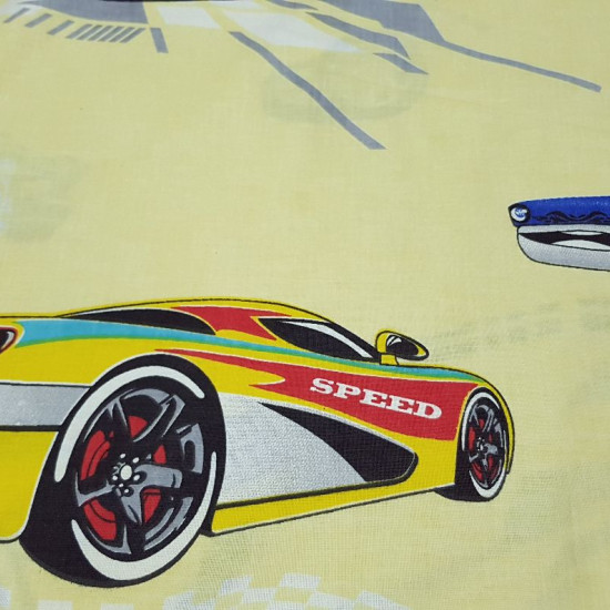 Cotton Cars Racing fabric - Decorative cotton fabric with drawings of large racing cars on a light yellow background. The fabric is 160cm wide and its composition is 100% cotton.