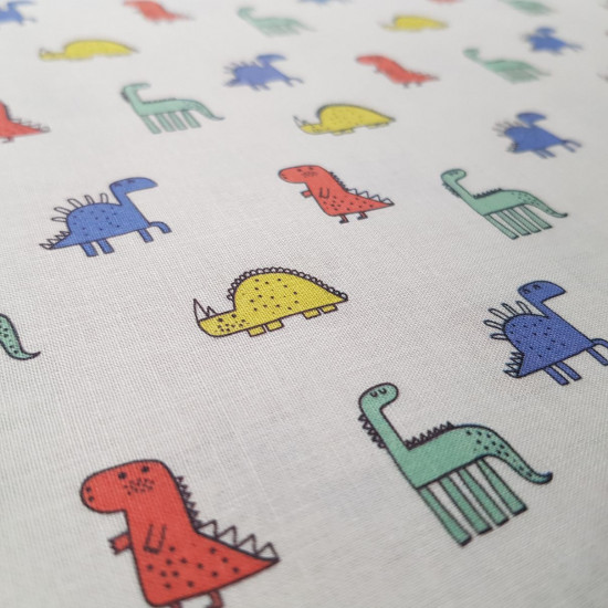 Cotton Colorful Dinosaurs fabric - Cotton poplin fabric with drawings of colorful dinosaurs on a white background. The orientation of the drawing is vertical with respect to the width (see photos where you can see the meter) The fabric measures 140cm