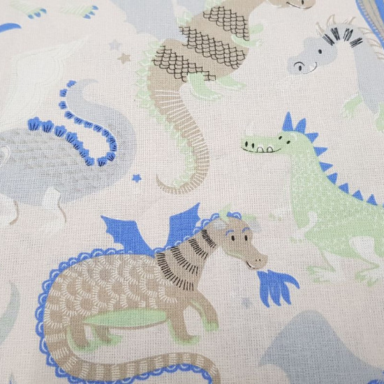 Cotton Funny Dragons fabric - Cotton fabric with drawings of funny dragons in shades of blue, green and gray on a light background with stars. The fabric is 155cm wide and its composition is 100% cotton.