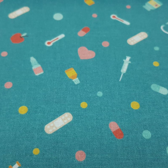 Cotton Medical Instruments fabric - Poplin cotton fabric with drawings of medical instruments and utensils, such as thermometers, syringes, stethoscopes, bandages, medicines... on an blue petrol background with hearts and pills. The fabric is 150cm wid