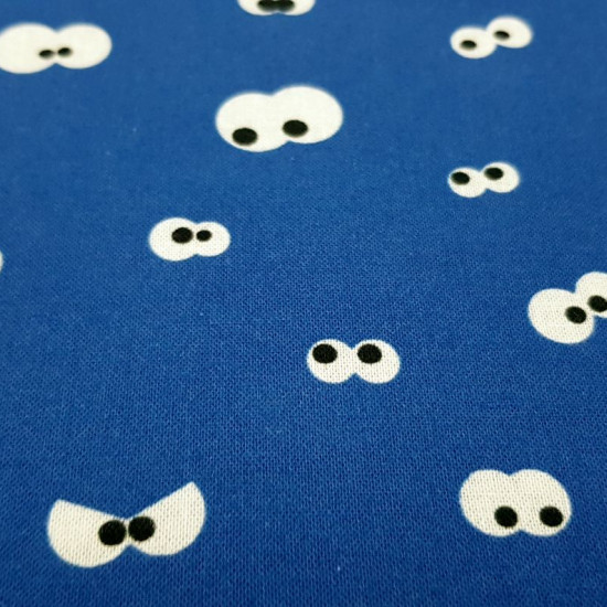 Cotton Eyes Looking Blue fabric - Cotton fabric with drawings of peeping eyes on a blue background. The fabric is 150cm wide and its composition is 100% cotton.
