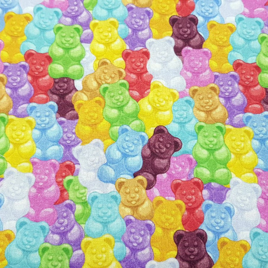 Cotton Gummy Bears fabric - Cotton fabric with drawings of colored gummy bears. The fabric is 150cm wide and its composition is 100% cotton.