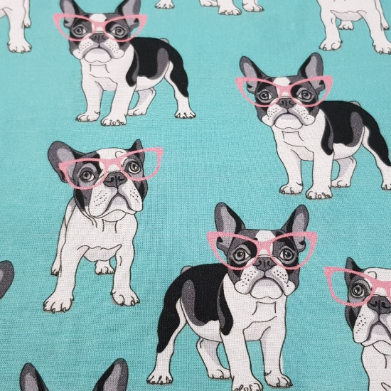 Tela Algodón Perros Gafas - Tela divertida de algodón con dibujos de perros con gafas rosas sobre un fondo de color turquesa. La tela mide 140cm de ancho y su composición 100% algodón.