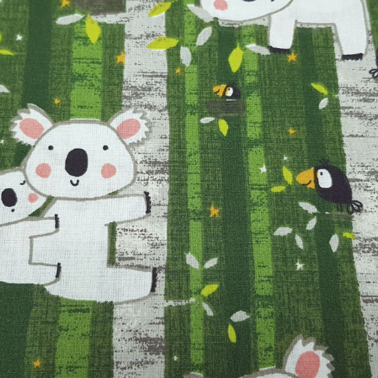 Cotton Cretonne Koalas and Birds Green fabric - Crettone cotton fabric, with more weight than cotton poplin, with drawings of koalas and birds in the trees on a predominantly green background. The fabric is 160cm wide and its composition is 100% cotton.