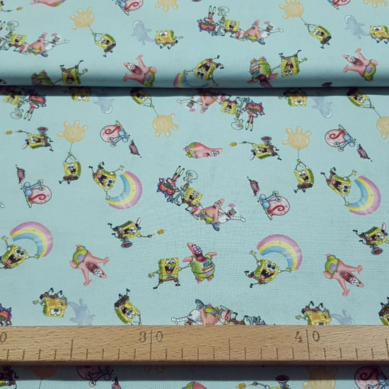 Cotton Rainbow Spongebob fabric - Licensed cotton fabric with drawings of SpongeBob characters on a light background with rainbows and balloons. The fabric measures between 140-150cm wide and its composition is 100% cotton.