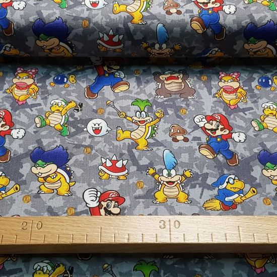 Cotton Super Mario Villains fabric - Licensed cotton fabric with drawings of the villainous characters from the video game Super Mario, on a gray background. The fabric is 110cm wide and its composition is 100% cotton.