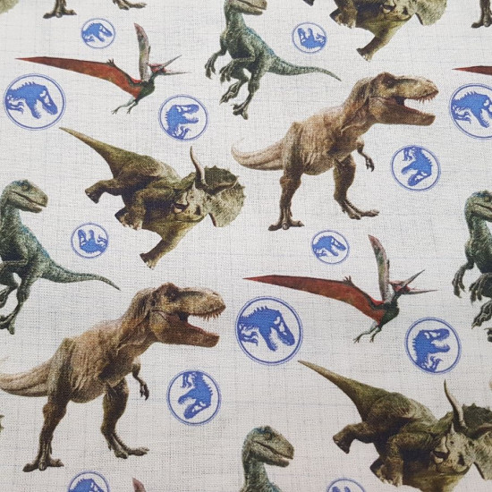 Cotton Jurassic World Dinos fabric - Licensed cotton fabric with drawings of dinosaurs and logos from the Jurassic World movie. The fabric measures between 140-150cm wide and its composition is 100% cotton.