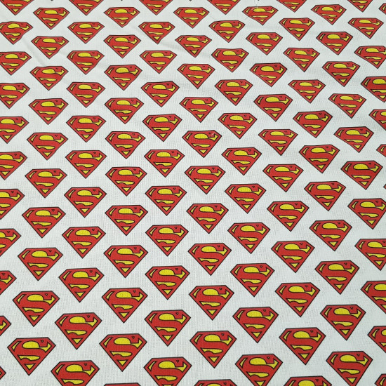 Cotton Superman Logos fabric - Licensed cotton fabric with drawings of Superman logos on a white background. The fabric measures between 140-150cm wide and its composition is 100% cotton.