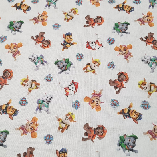 Cotton Paw Patrol Characters fabric - Licensed cotton fabric with drawings of the characters from the Paw Patrol series on a light background with gray phrases. The fabric measures between 140-150cm wide and its composition is 100% cotton.