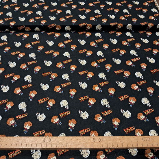 Cotton Back to the Future fabric - Patchwork poplin cotton fabric with drawings representing the characters Marty McFly and Doc from the long-awaited movie Back to the Future, and logos of the movie on a black background. The fabric measures 110cm wid