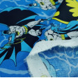 Cotton Batman Blue fabric - Cotton fabric with drawings of the superhero Batman in various poses and Batman logos on a background with rays where the color blue predominates. The fabric is 110cm wide and its composition is 100% cotton.