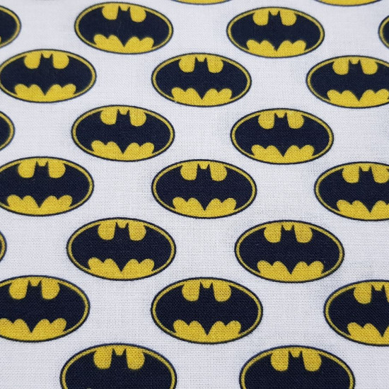 Cotton Batman Logos fabric - Licensed cotton fabric with Batman logo drawings on a white background. The fabric measures between 140-150cm wide and its composition is 100% cotton.