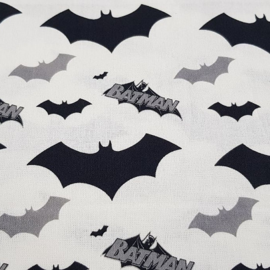 Cotton Batman Bats fabric - Cotton fabric with bat drawings and Batman logos in black and gray tones on a white background. The fabric is 140cm wide and its composition is 100% cotton.