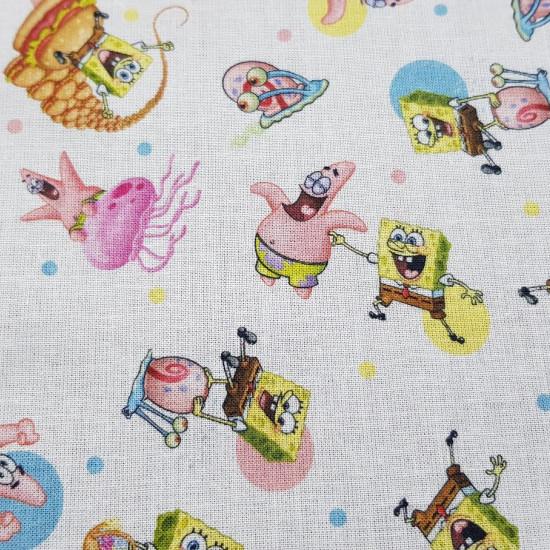 Cotton Spongebob Characters fabric - Licensed cotton fabric with drawings of SpongeBob characters on a white background with colorful polka dots. The fabric measures between 140-150cm wide and its composition is 100% cotton.