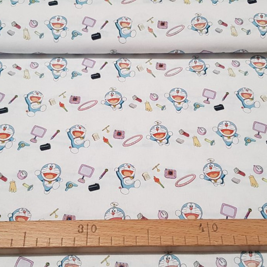 Cotton Doraemon Magic Items fabric - Children's cotton fabric with drawings of the character Doraemon and magical objects around him on a white background. The fabric is 150cm wide and its composition is 100% cotton.