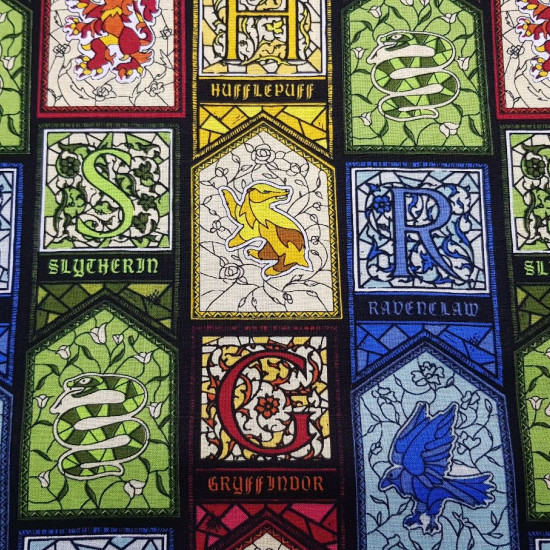 Cotton Harry Potter Stained Glass fabric - Licensed cotton fabric with colorful stained glass drawings representing the different Hogwarts houses from the Harry Potter saga. The fabric is 110cm wide and its composition is 100% cotton.