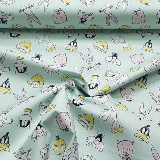 Cotton Looney Tunes fabric - Licensed cotton fabric with drawings of the characters of the Warner Looney Tunes, where the rabbit Bugs Bunny, Daffy Duck, Taz, Sylvester the cat, Porky... appear on a light green background. The fabric is 110cm wid