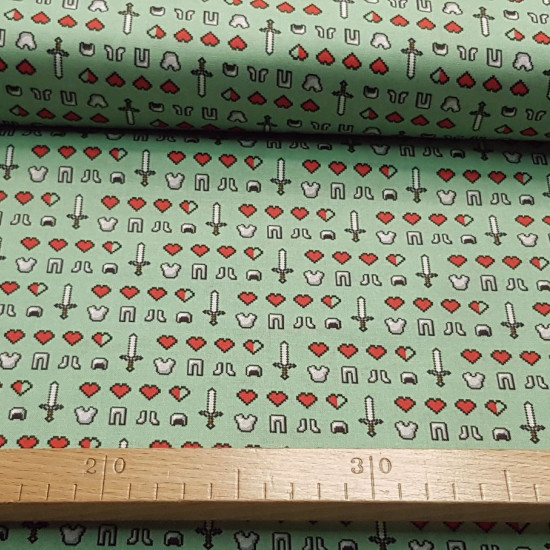 Cotton Minecraft Symbols Emojis fabric - Licensed cotton fabric with drawings of symbols and emojis from the Minecraft video game on a green background. The fabric is 110cm wide and its composition is 100% cotton.