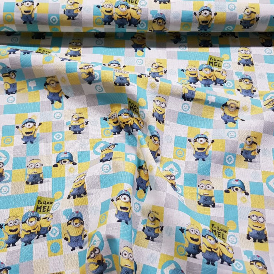 Cotton Minions Grids fabric - Licensed cotton fabric with the characters from the movie Minions on a background of colored squares. The fabric measures 150cm wide and its composition is 100% cotton.
