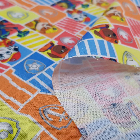 Cotton Paw Patrol Shields fabric - Licensed cotton fabric with drawings of the Paw Patrol characters on a background of colored frames and shields. The fabric is 150cm wide and its composition is 100% cotton.