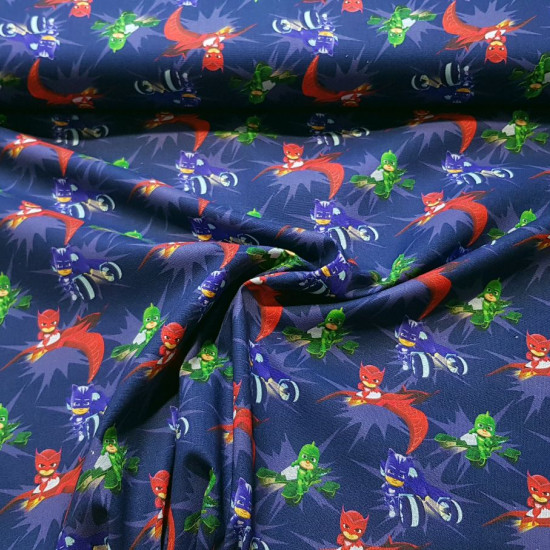 Cotton PJ Masks Vehicles fabric - Licensed cotton poplin fabric with drawings of the PJ Masks characters with their vehicles on a dark blue background. The fabric measures 140cm wide and its composition is 100% cotton.