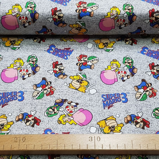 Cotton Super Mario Bros 3 fabric - Licensed cotton fabric with drawings of the characters from the video game Super Mario Bros 3, on a gray background. Mario, Luigi, Peach, Toad characters appear... The fabric is 110cm wide and its composition is 100%