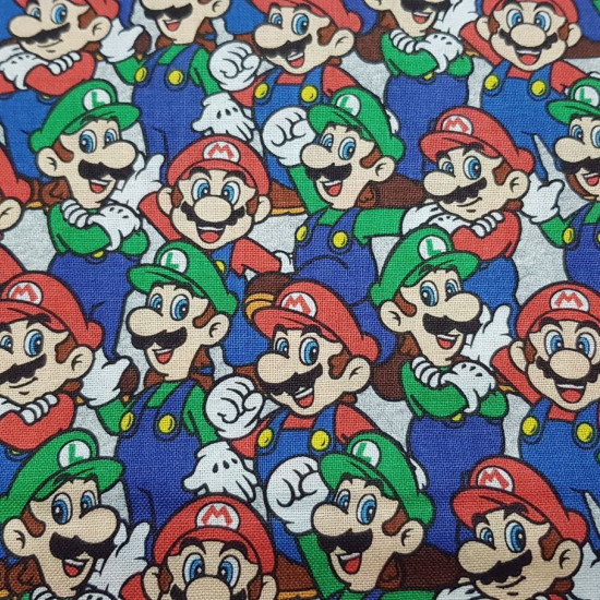 Cotton Super Mario Luigi Mosaic fabric - Licensed cotton fabric with drawings of the characters Mario and Luigi from the video game Super Mario forming a mosaic. The fabric is 110cm wide and its composition is 100% cotton.